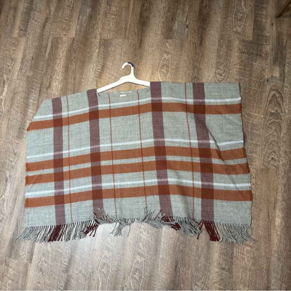a new day plaid poncho in burnt orange (or rust), burgundy, and gray.